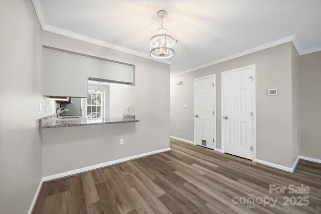 a view of room with wooden floor