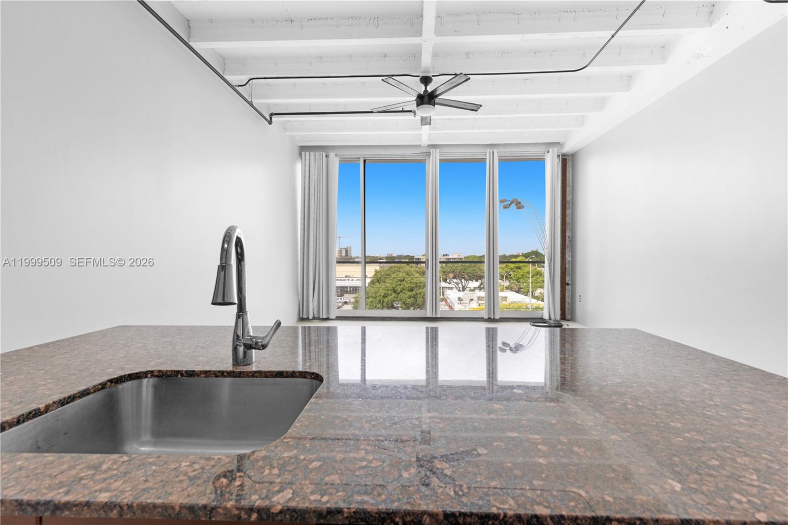8101 Biscayne Boulevard, Unit R414 Miami, FL 33138 - Photo 4 of 27 a kitchen with a sink and a large window