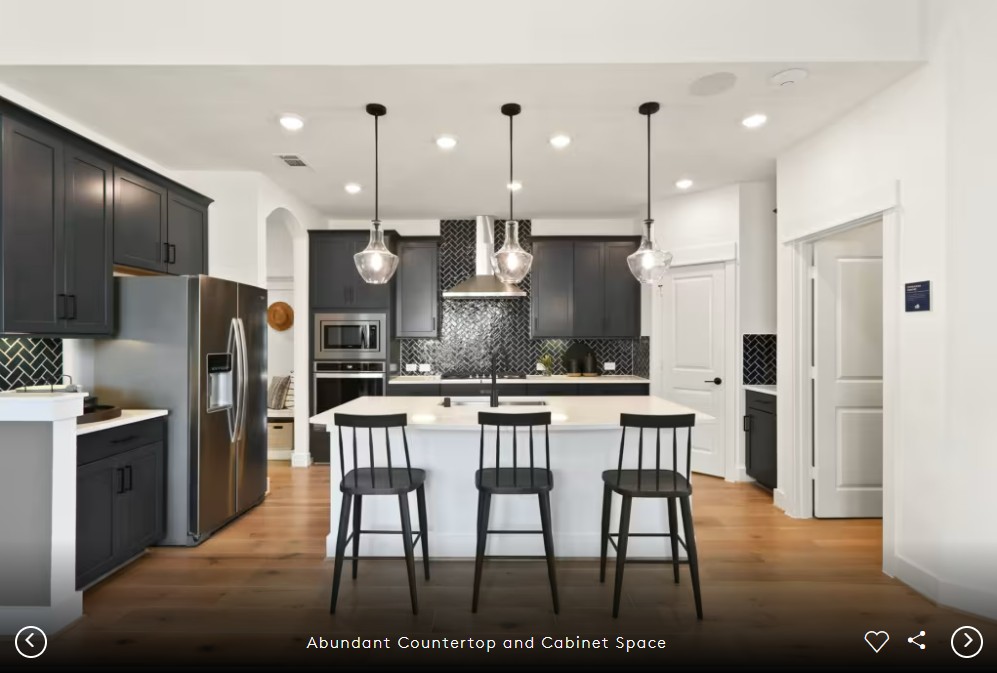 2913 Zuni Path Leander, TX 78641 - Photo 7 of 17 a kitchen with stainless steel appliances kitchen island granite countertop a refrigerator a stove a sink a dining table and chairs