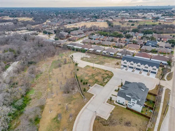 an aerial view of residential houses with outdoor space