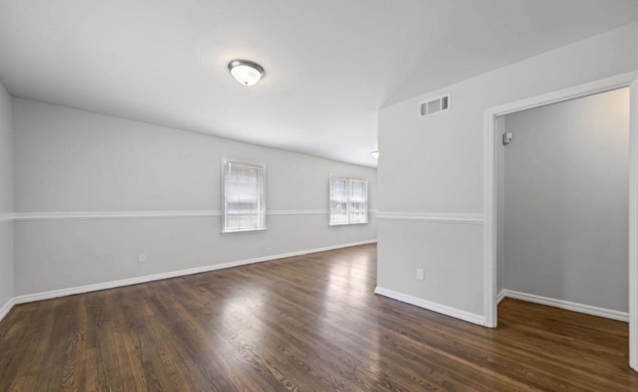 3843 Blue Jay Road Memphis, TN 38116 - Photo 5 of 23 a view of an empty room with wooden floor and a window