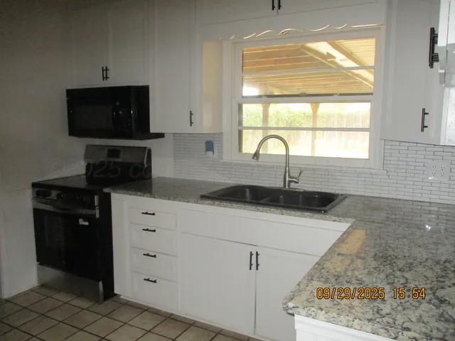 a kitchen with a sink and a window