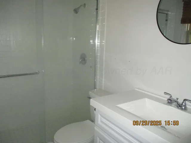 a bathroom with a sink a toilet and a mirror