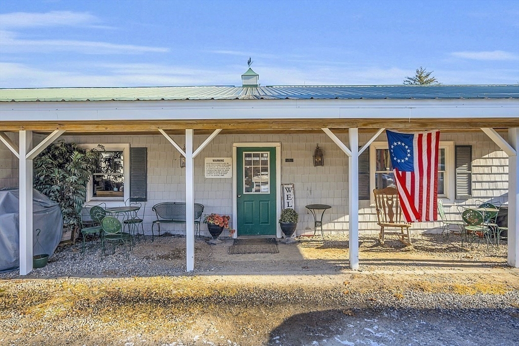 84 Powers Road Westford, MA 01886 - Photo 12 of 42 a view of swimming pool with lawn chairs and couches