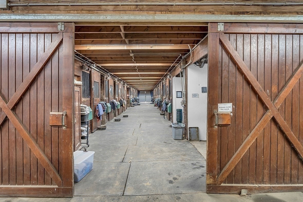 84 Powers Road Westford, MA 01886 - Photo 18 of 42 a view of a hallway with wooden floors and stairs