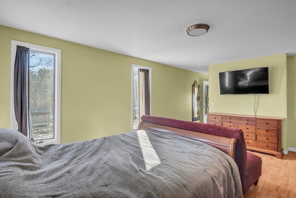 84 Powers Road Westford, MA 01886 - Photo 39 of 42 a bedroom with a bed and a flat screen tv