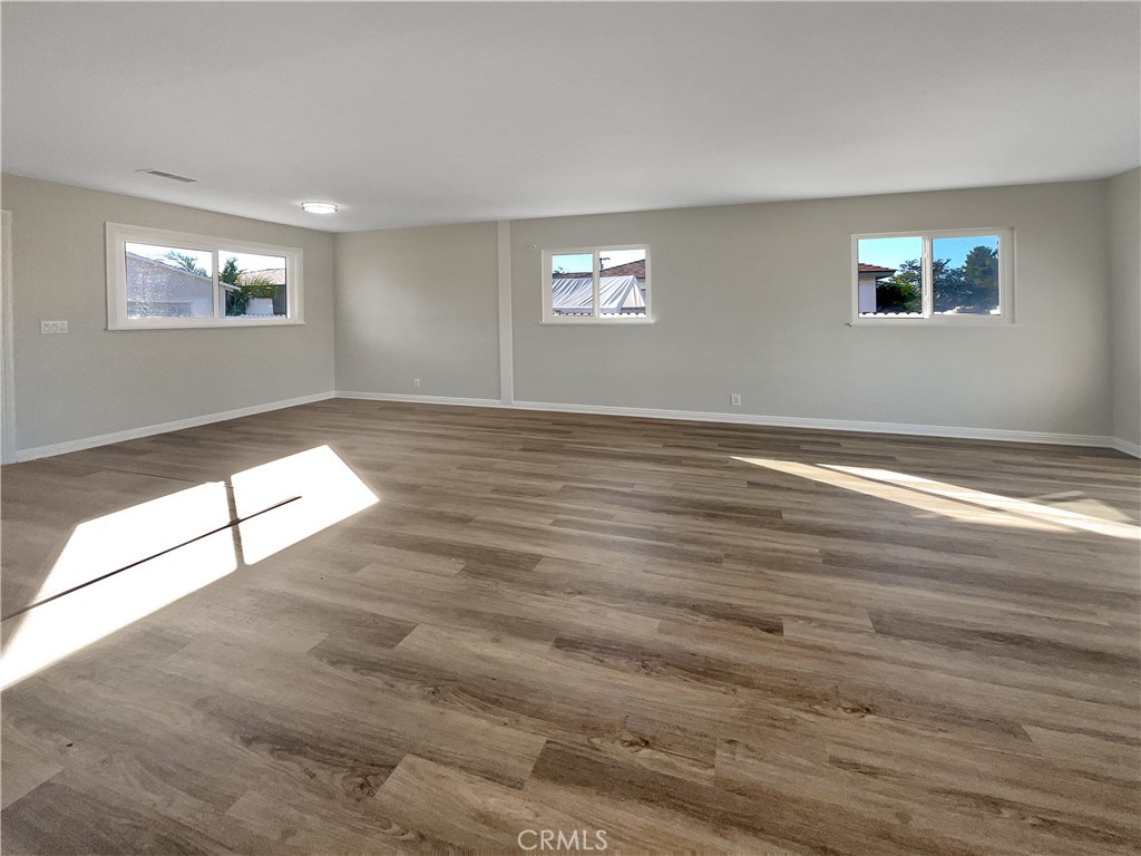 380 Harvard Street Oxnard, CA 93036 - Photo 3 of 14 a view of an empty room with wooden floor and a window