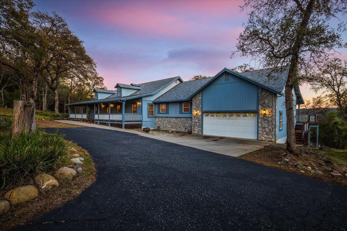 23437 Meyer Ravine Road Grass Valley, CA 95949 - Photo 1 of 1 a front view of a house with a yard and garage