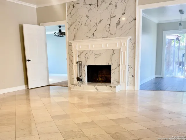 an empty room with wooden floor and fireplace