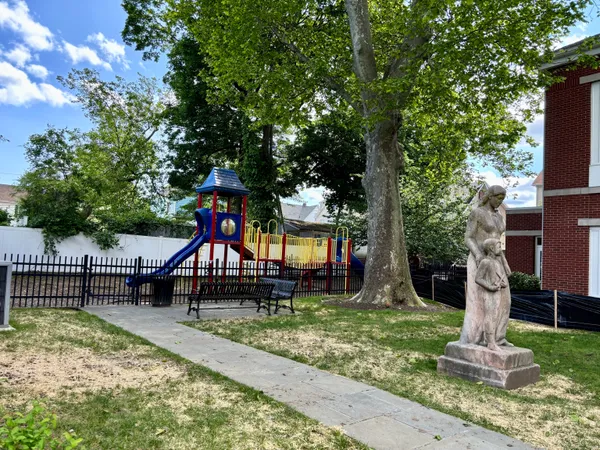 a park with a bench and trees