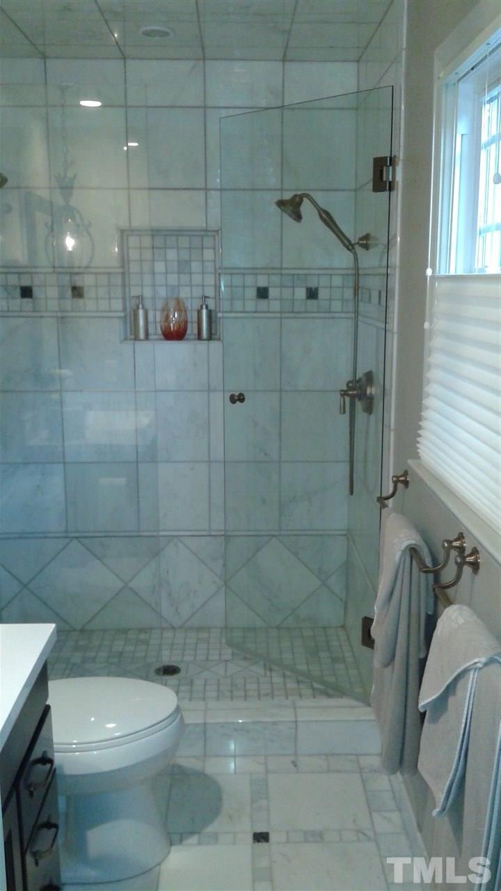 204 Sampson Street Raleigh, NC 27609 - Photo 12 of 22 a bathroom with a shower a toilet and sink