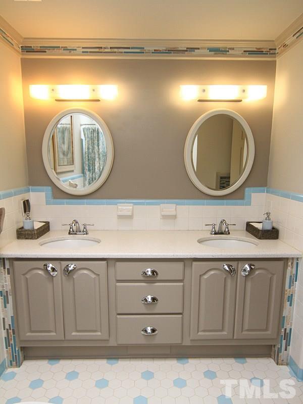 204 Sampson Street Raleigh, NC 27609 - Photo 14 of 22 a bathroom with a sink and a mirror