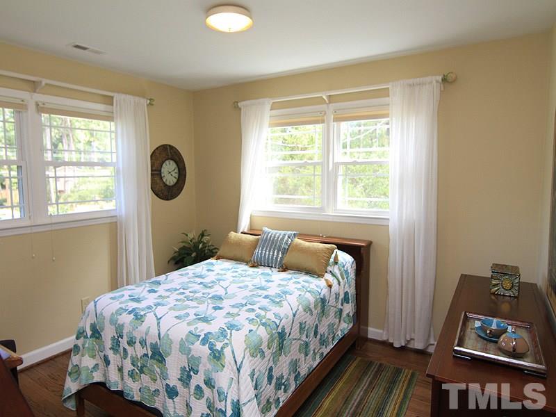 204 Sampson Street Raleigh, NC 27609 - Photo 15 of 22 a bedroom with a bed and a window
