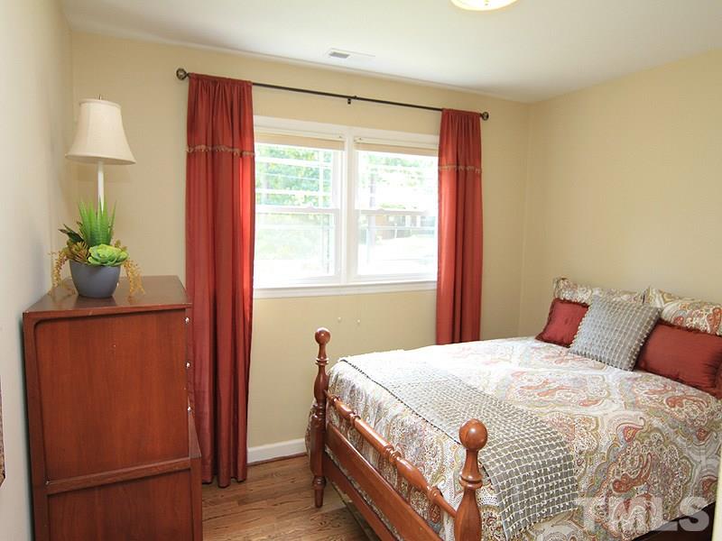 204 Sampson Street Raleigh, NC 27609 - Photo 16 of 22 a bedroom with a bed and a window