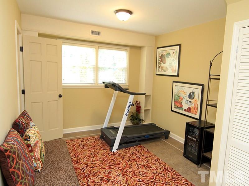 204 Sampson Street Raleigh, NC 27609 - Photo 19 of 22 a view of a room with wooden floor and windows
