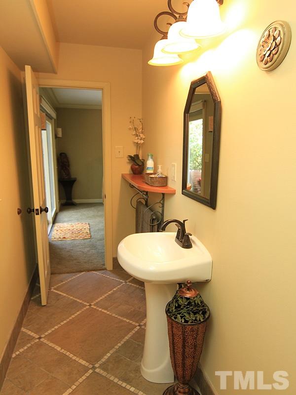 204 Sampson Street Raleigh, NC 27609 - Photo 20 of 22 a bathroom with a sink a toilet and a mirror