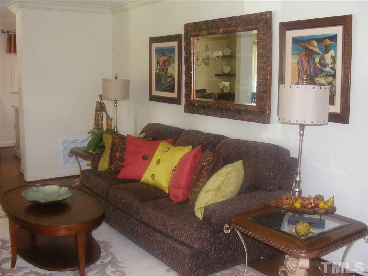 204 Sampson Street Raleigh, NC 27609 - Photo 3 of 22 a living room with furniture and a painting on the wall