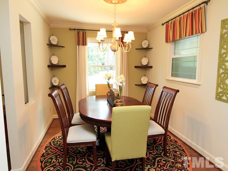 204 Sampson Street Raleigh, NC 27609 - Photo 4 of 22 a view of a dining room with furniture and chandelier
