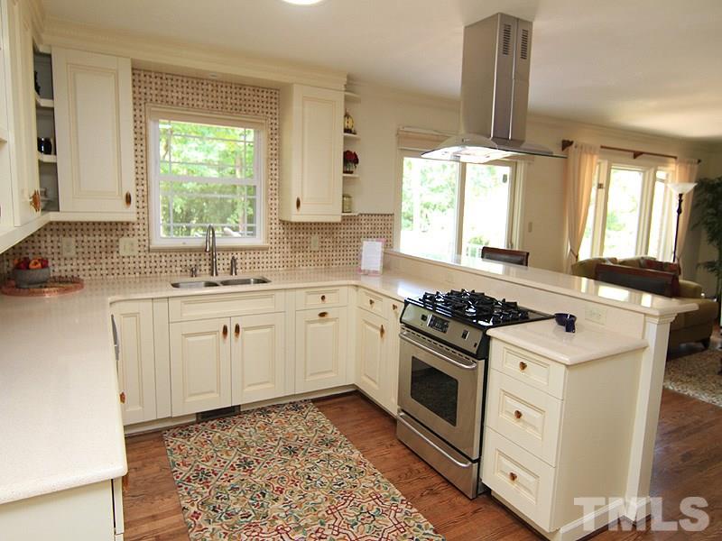 204 Sampson Street Raleigh, NC 27609 - Photo 5 of 22 a kitchen with a stove a sink and a window
