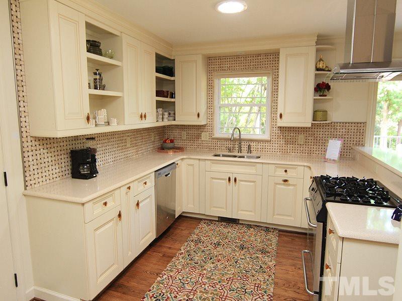 204 Sampson Street Raleigh, NC 27609 - Photo 6 of 22 a kitchen with stainless steel appliances a sink stove and cabinets