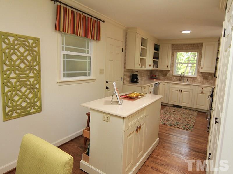 204 Sampson Street Raleigh, NC 27609 - Photo 7 of 22 a kitchen with a sink stove and cabinets