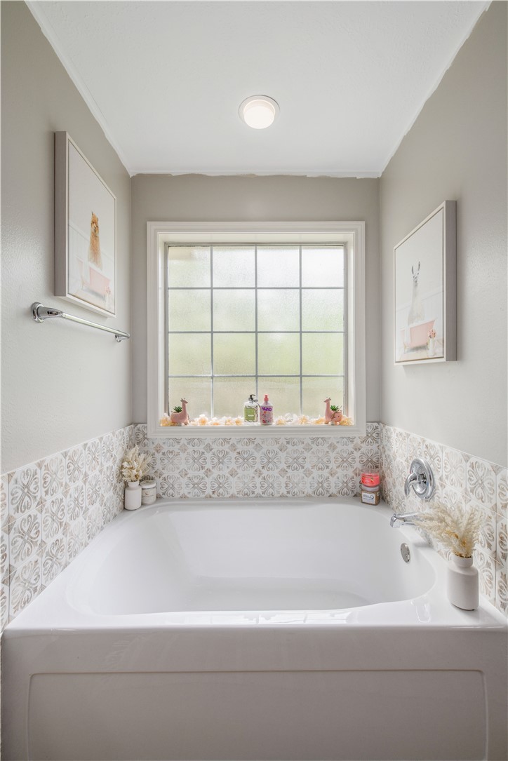 6538 Olympia Buddy Road College Station, TX 77845 - Photo 24 of 50 a bath tub sitting in a bathroom next to a window