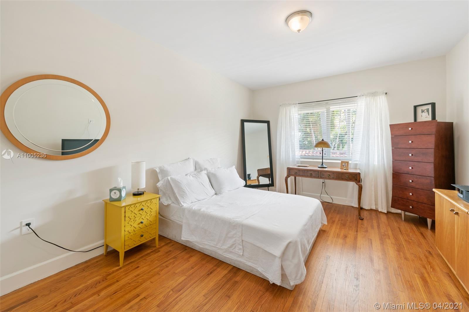 4780 Pine Tree Drive, Unit 9 Miami Beach, FL 33140 - Photo 5 of 21 a bedroom with a bed and wooden floor