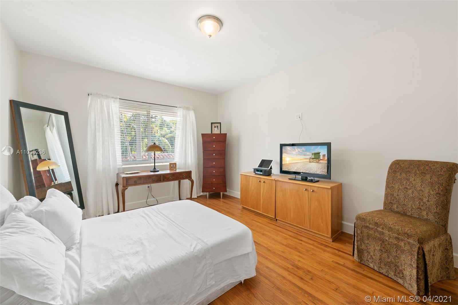 4780 Pine Tree Drive, Unit 9 Miami Beach, FL 33140 - Photo 9 of 21 a bedroom with a bed and a chair