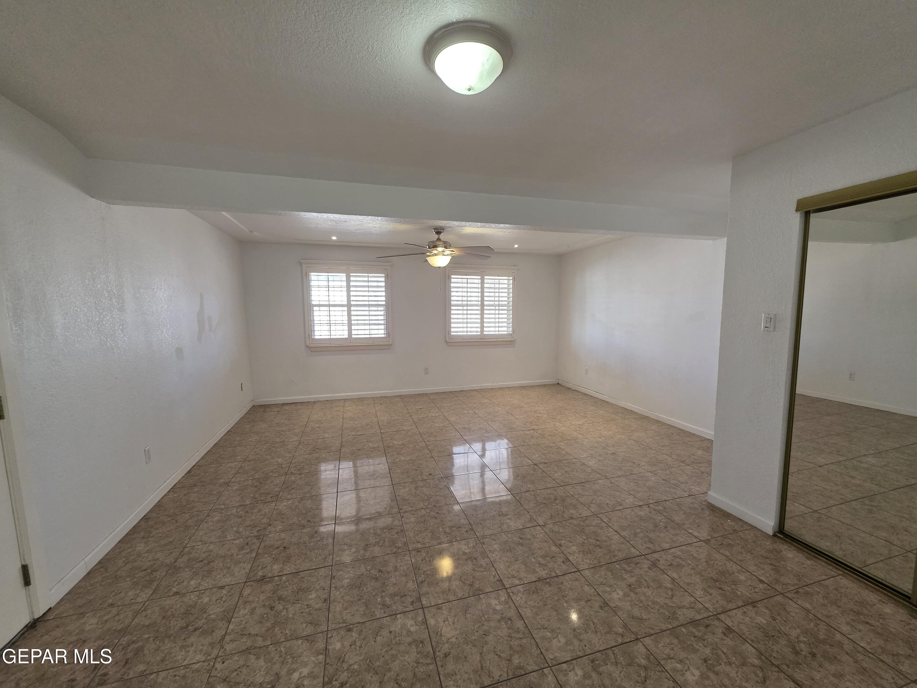 11661 Socorro Road Socorro, TX 79927 - Photo 13 of 32 wooden floor in an empty room with a window