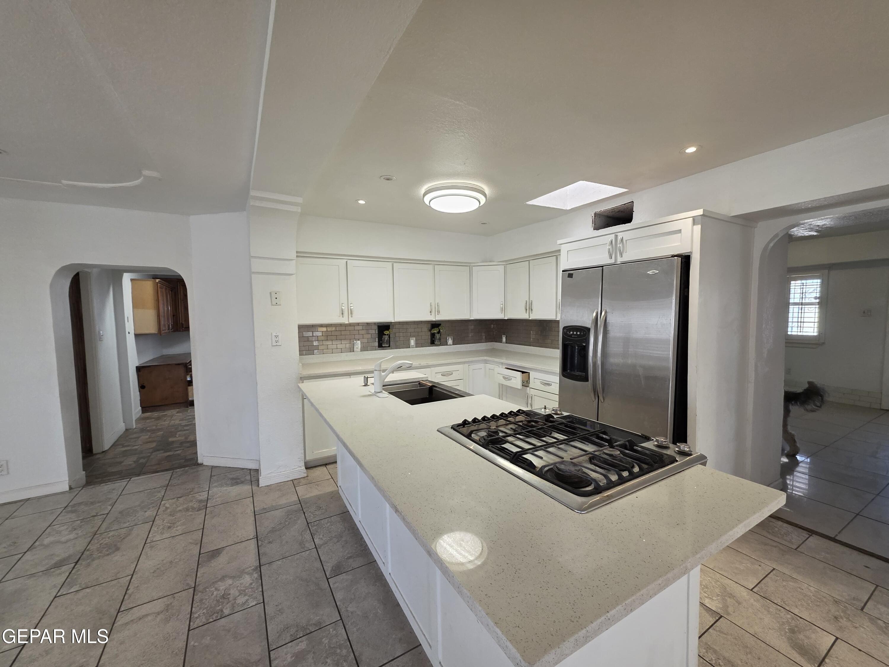 11661 Socorro Road Socorro, TX 79927 - Photo 15 of 32 a kitchen with stainless steel appliances granite countertop a stove a refrigerator and a sink