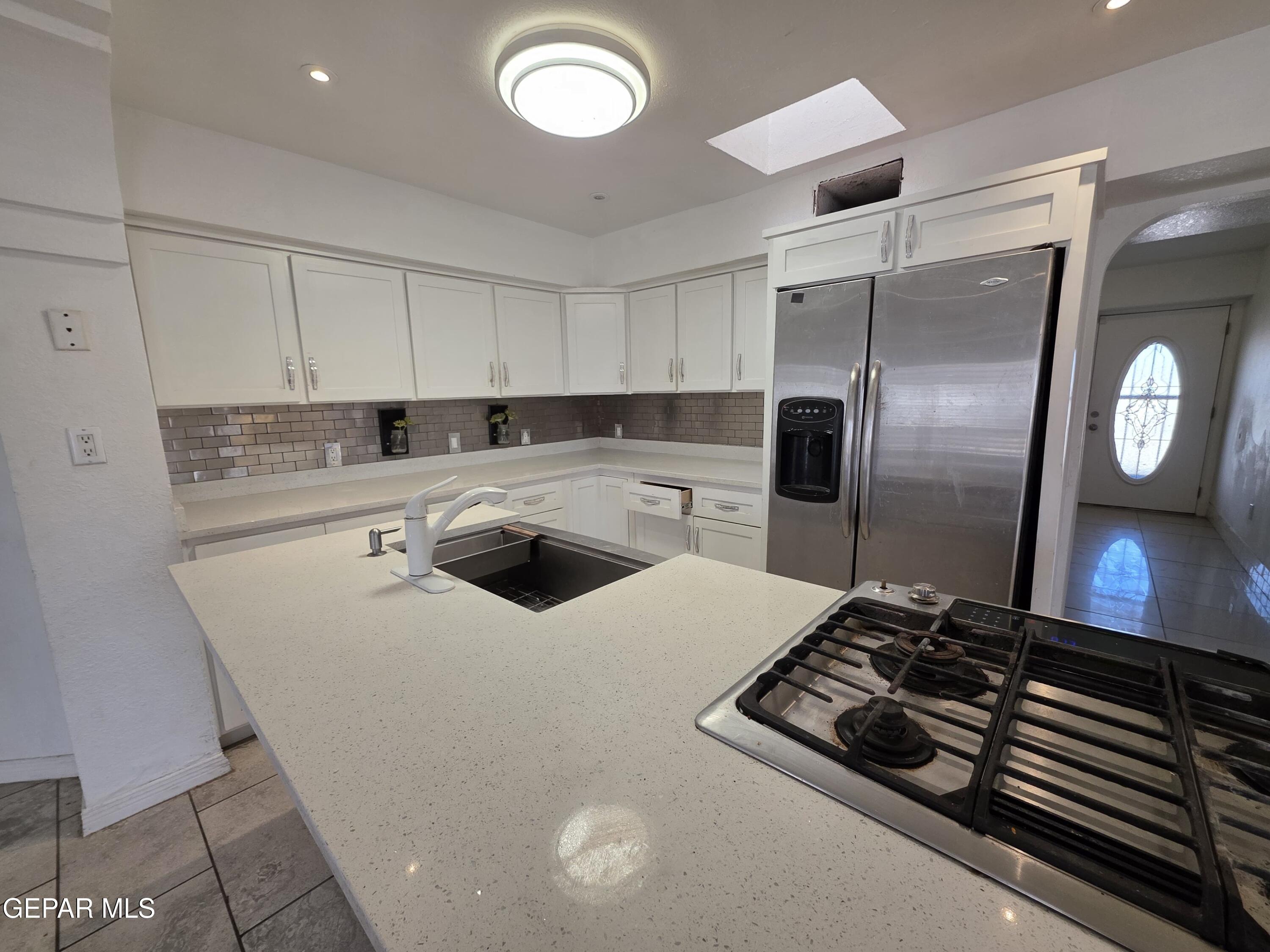 11661 Socorro Road Socorro, TX 79927 - Photo 16 of 32 a kitchen with stainless steel appliances a stove a refrigerator and a sink