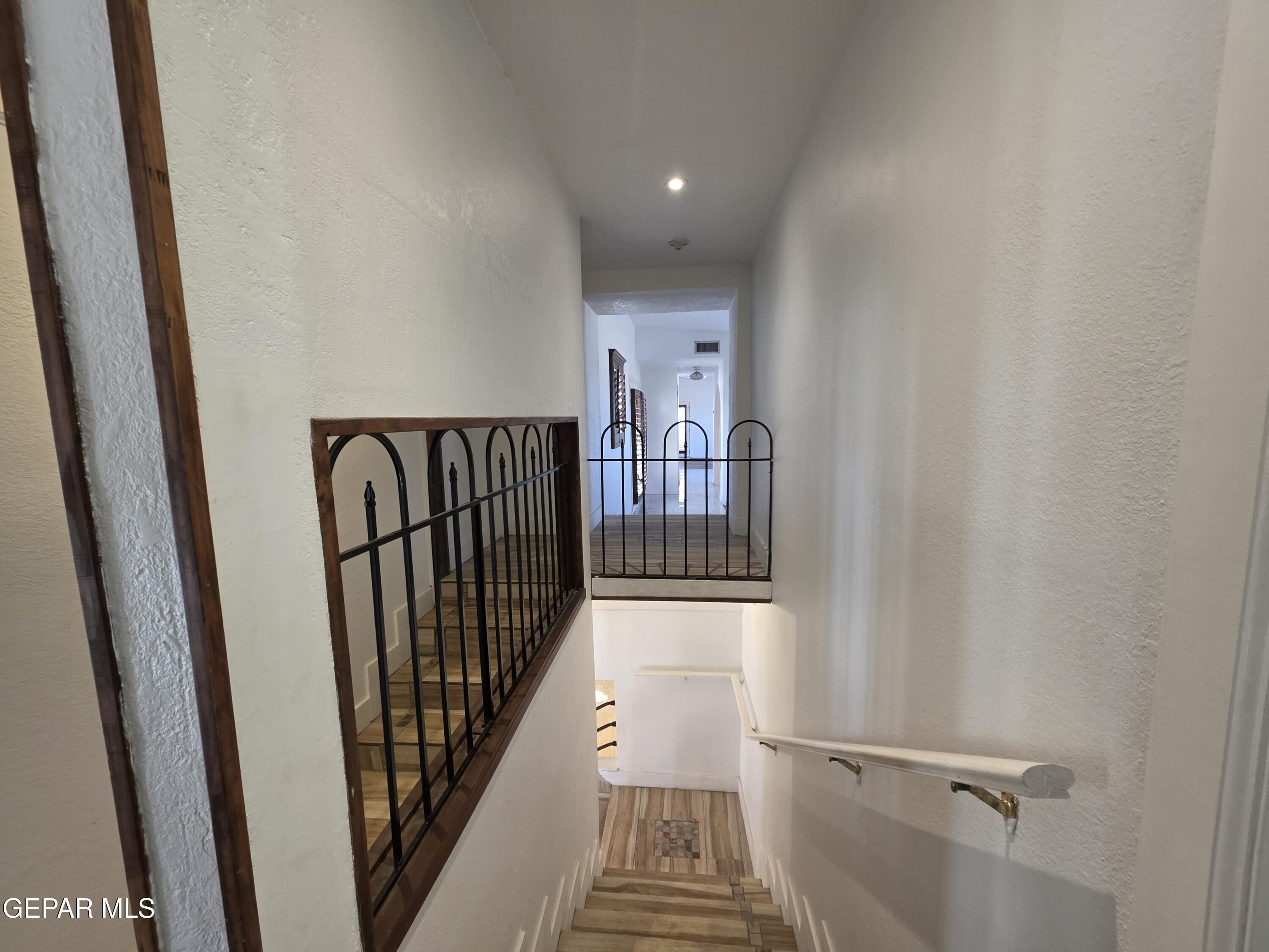 11661 Socorro Road Socorro, TX 79927 - Photo 19 of 32 a view of a hallway with wooden floor