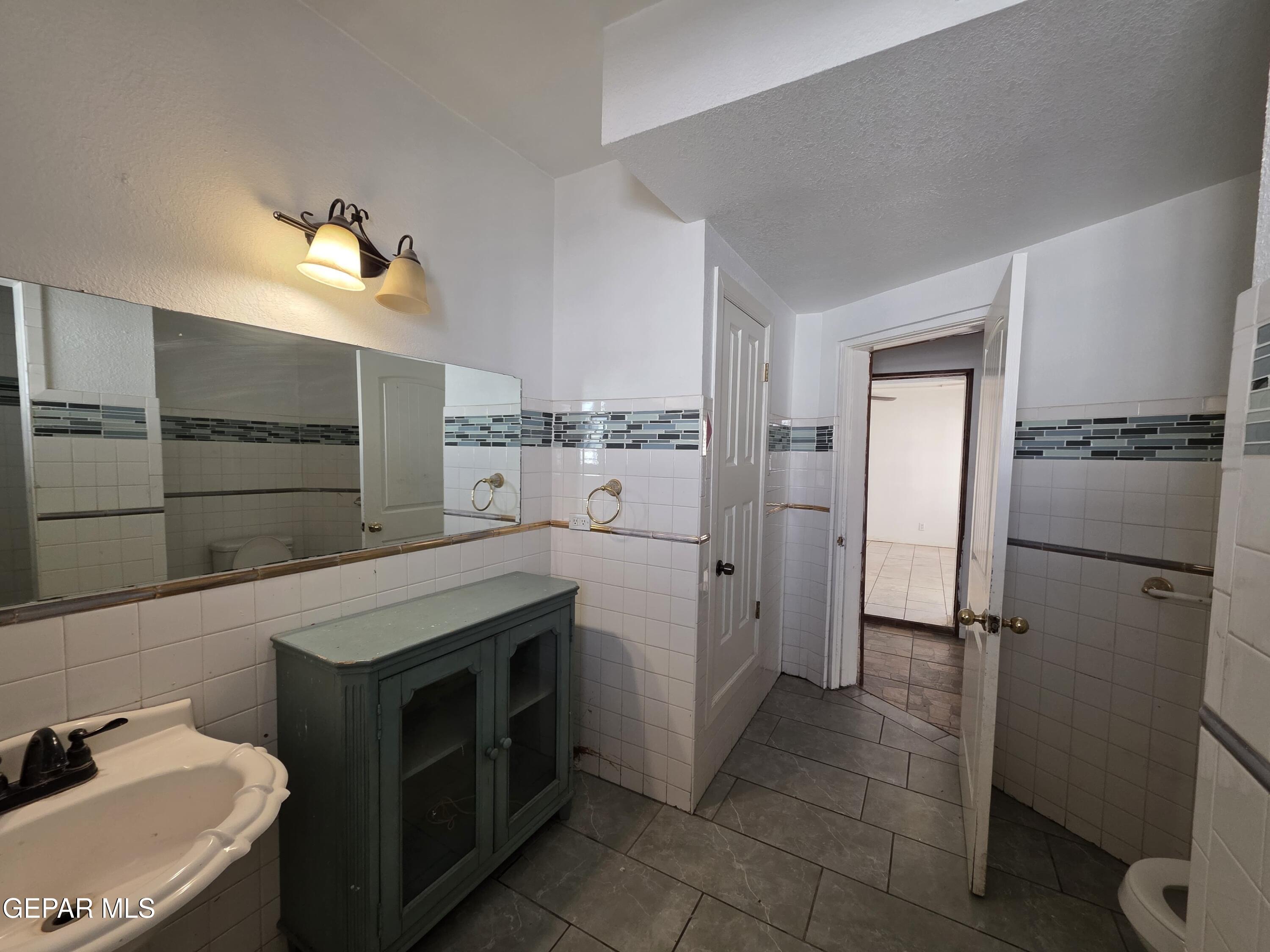 11661 Socorro Road Socorro, TX 79927 - Photo 20 of 32 a kitchen with a sink refrigerator and microwave