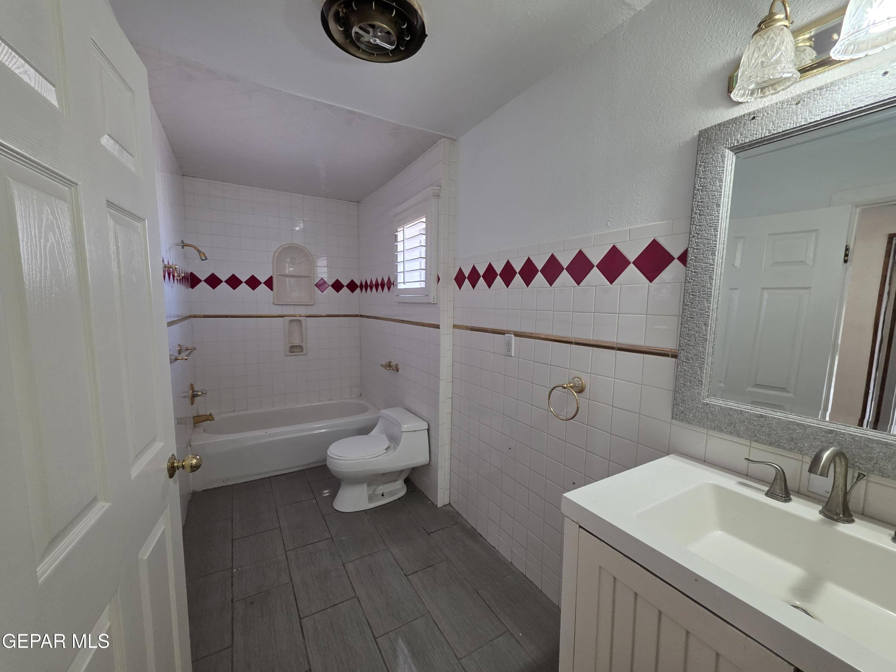 11661 Socorro Road Socorro, TX 79927 - Photo 21 of 32 a bathroom with a sink a toilet and a mirror