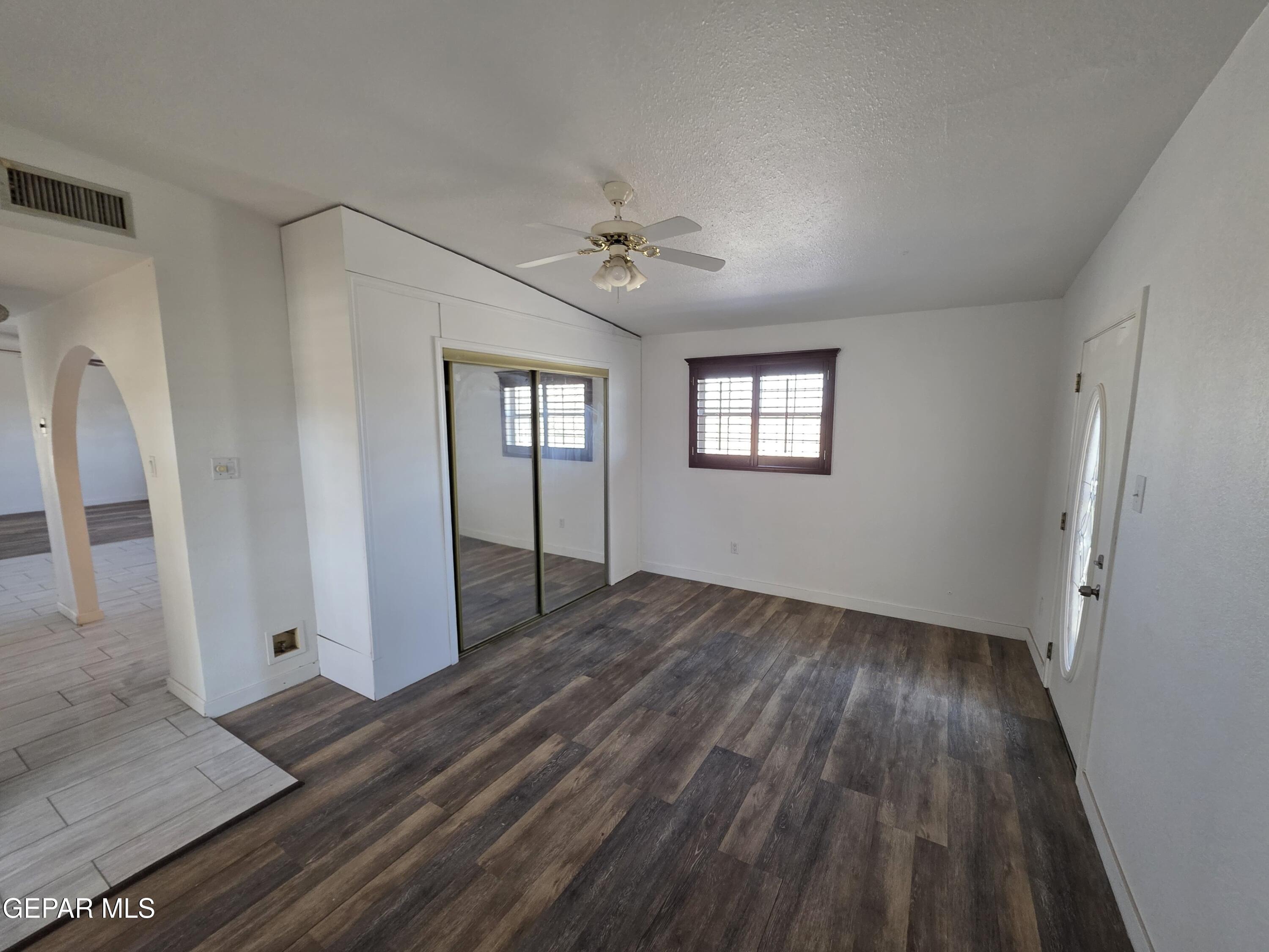 11661 Socorro Road Socorro, TX 79927 - Photo 22 of 32 wooden floor in an empty room with a window