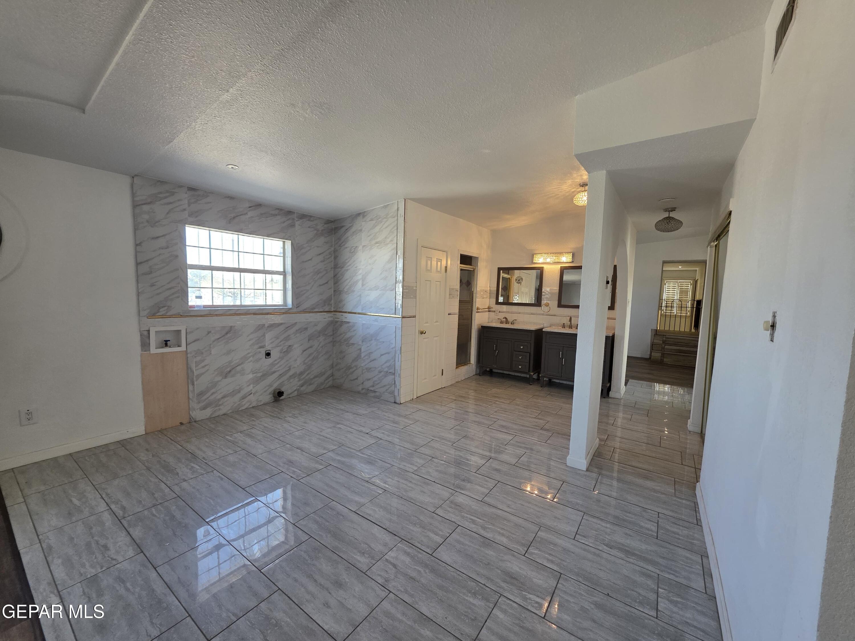 11661 Socorro Road Socorro, TX 79927 - Photo 23 of 32 an empty room with windows and entrance