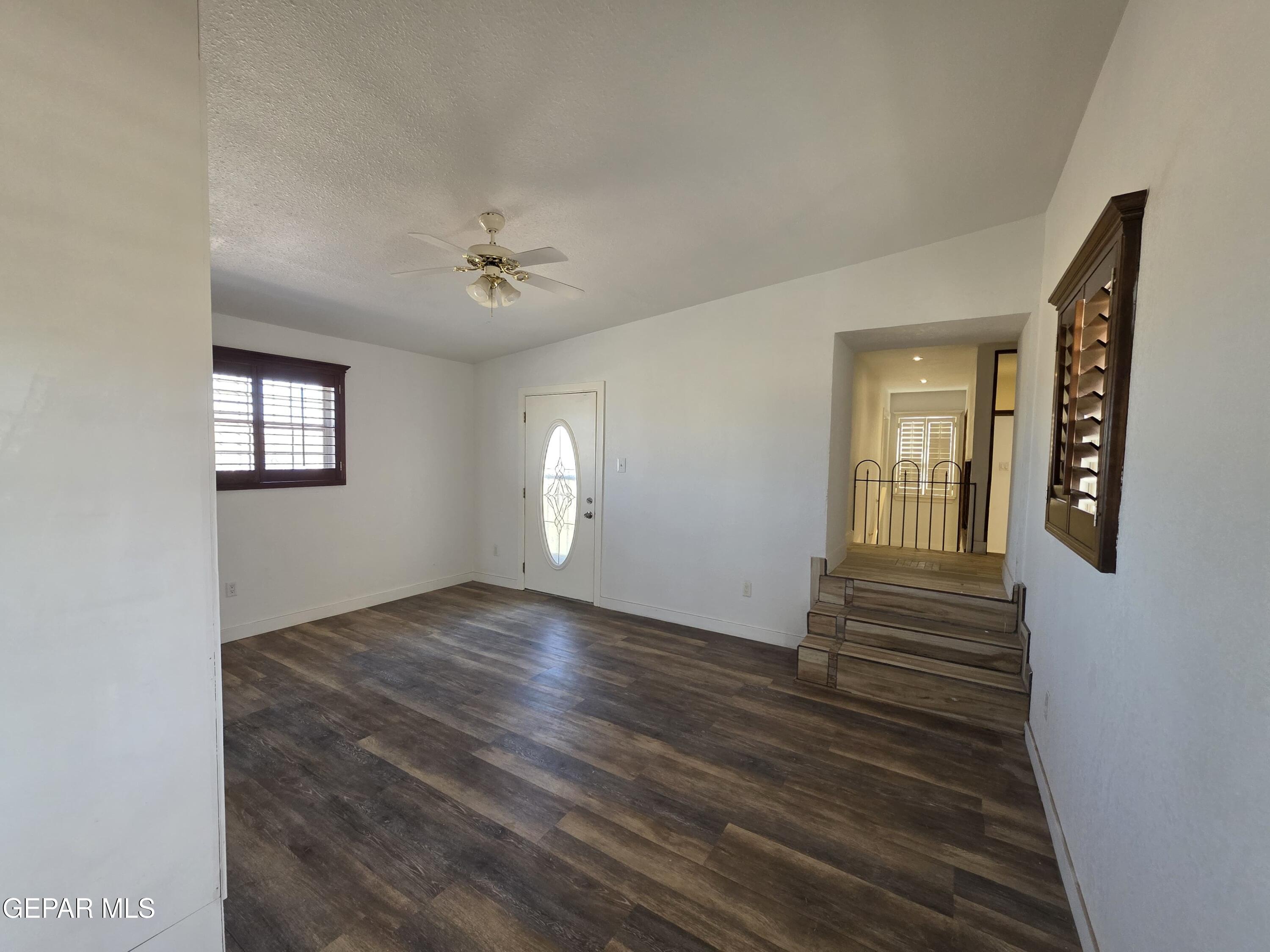 11661 Socorro Road Socorro, TX 79927 - Photo 25 of 32 a view of an empty room with window and wooden floor