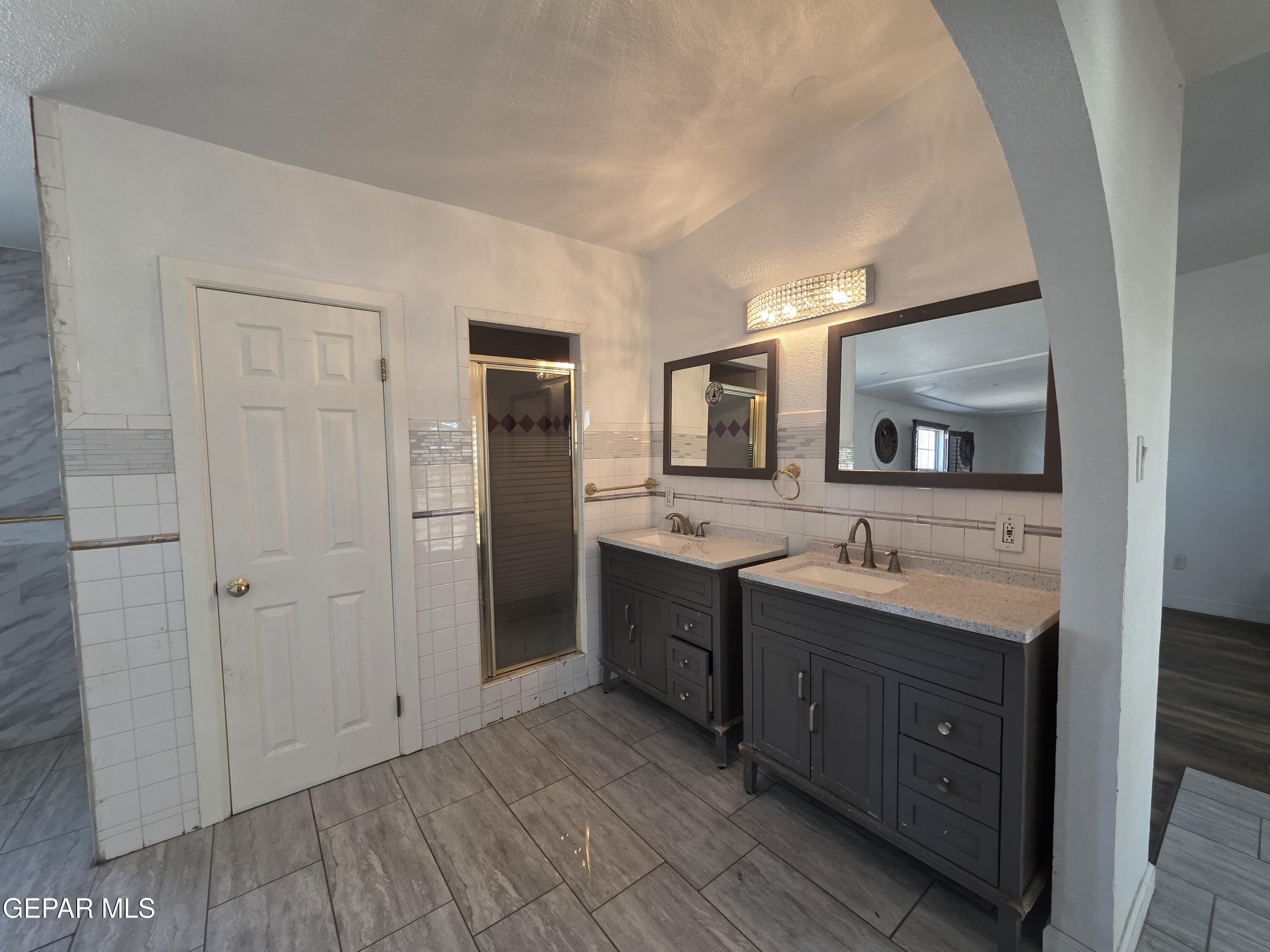 11661 Socorro Road Socorro, TX 79927 - Photo 28 of 32 a bathroom with a double vanity sink and mirror