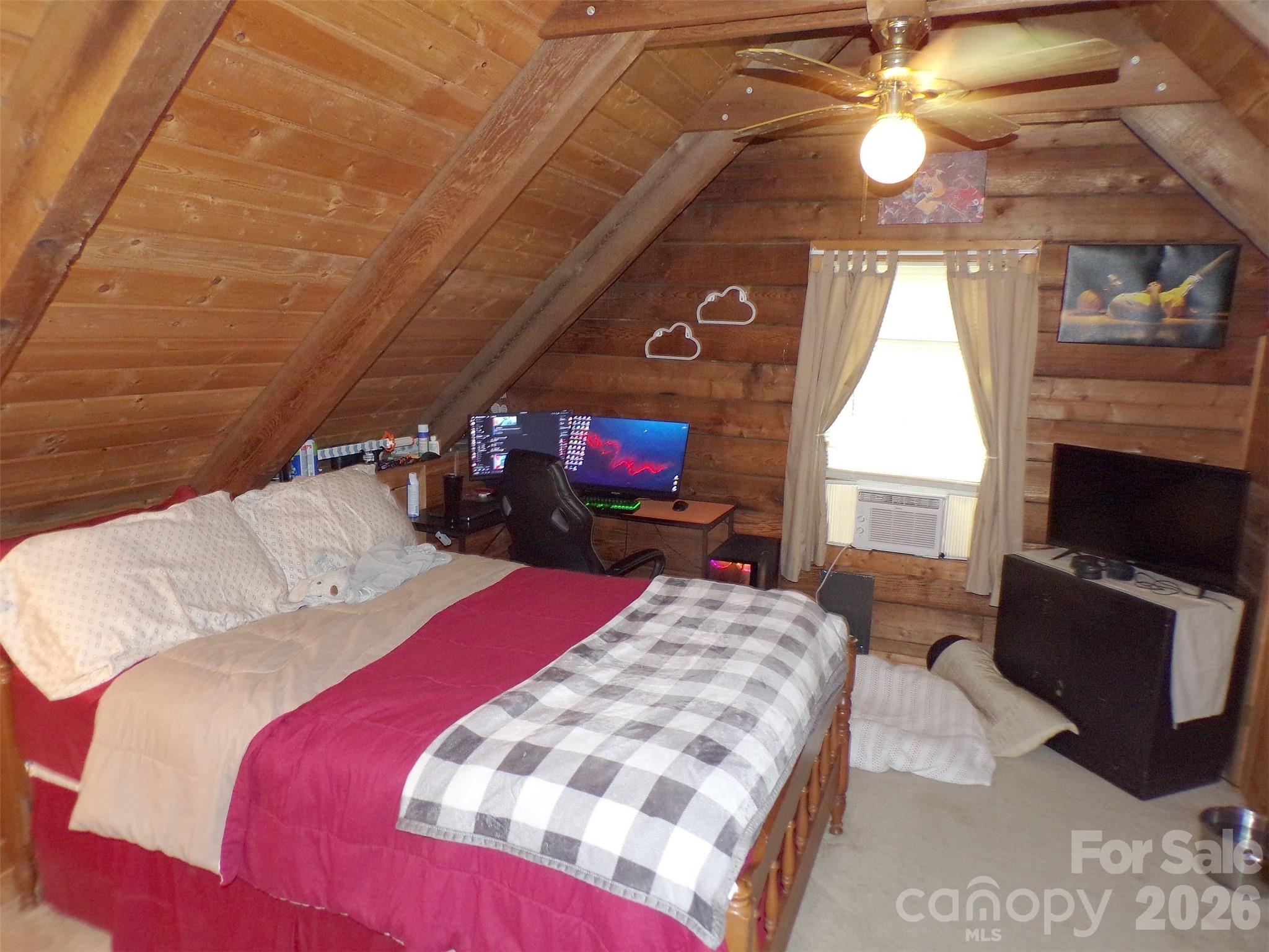 216 Paradise Road Hendersonville, NC 28792 - Photo 15 of 33 a bedroom with a bed and a fireplace