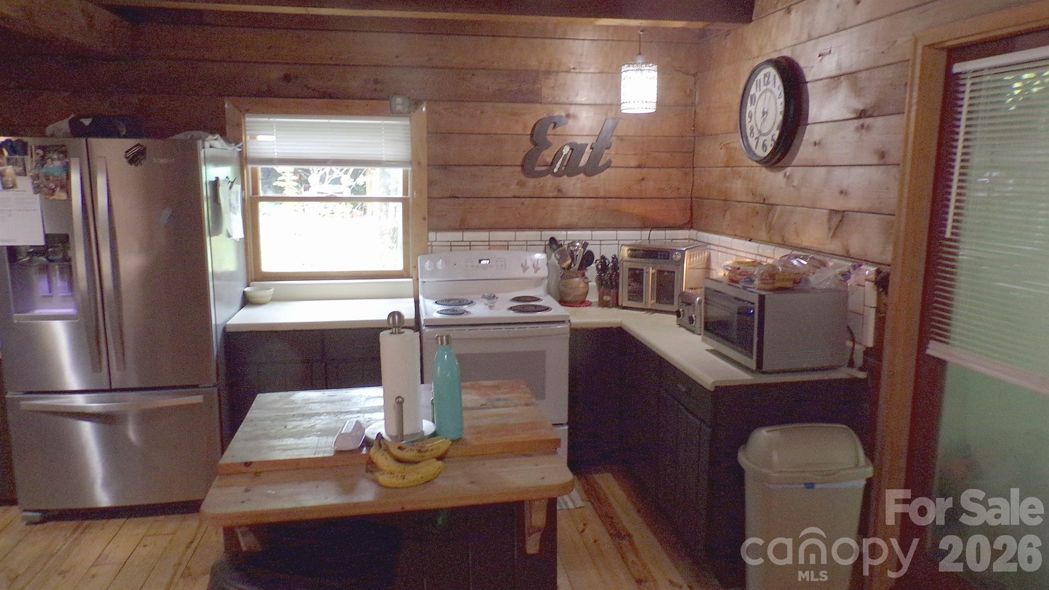 216 Paradise Road Hendersonville, NC 28792 - Photo 4 of 33 a kitchen with a refrigerator and a stove