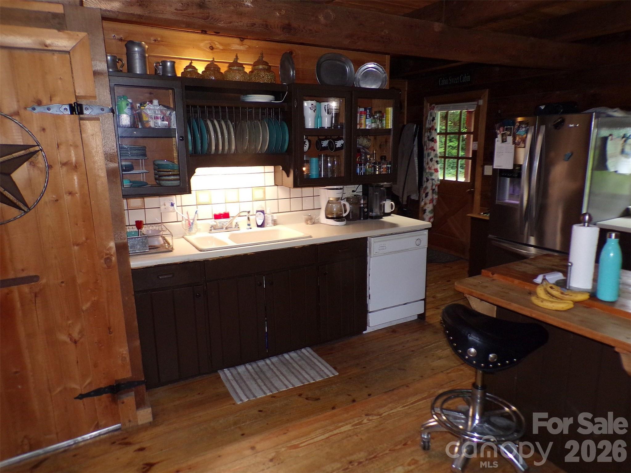 216 Paradise Road Hendersonville, NC 28792 - Photo 5 of 33 a kitchen with a sink and wooden cabinets