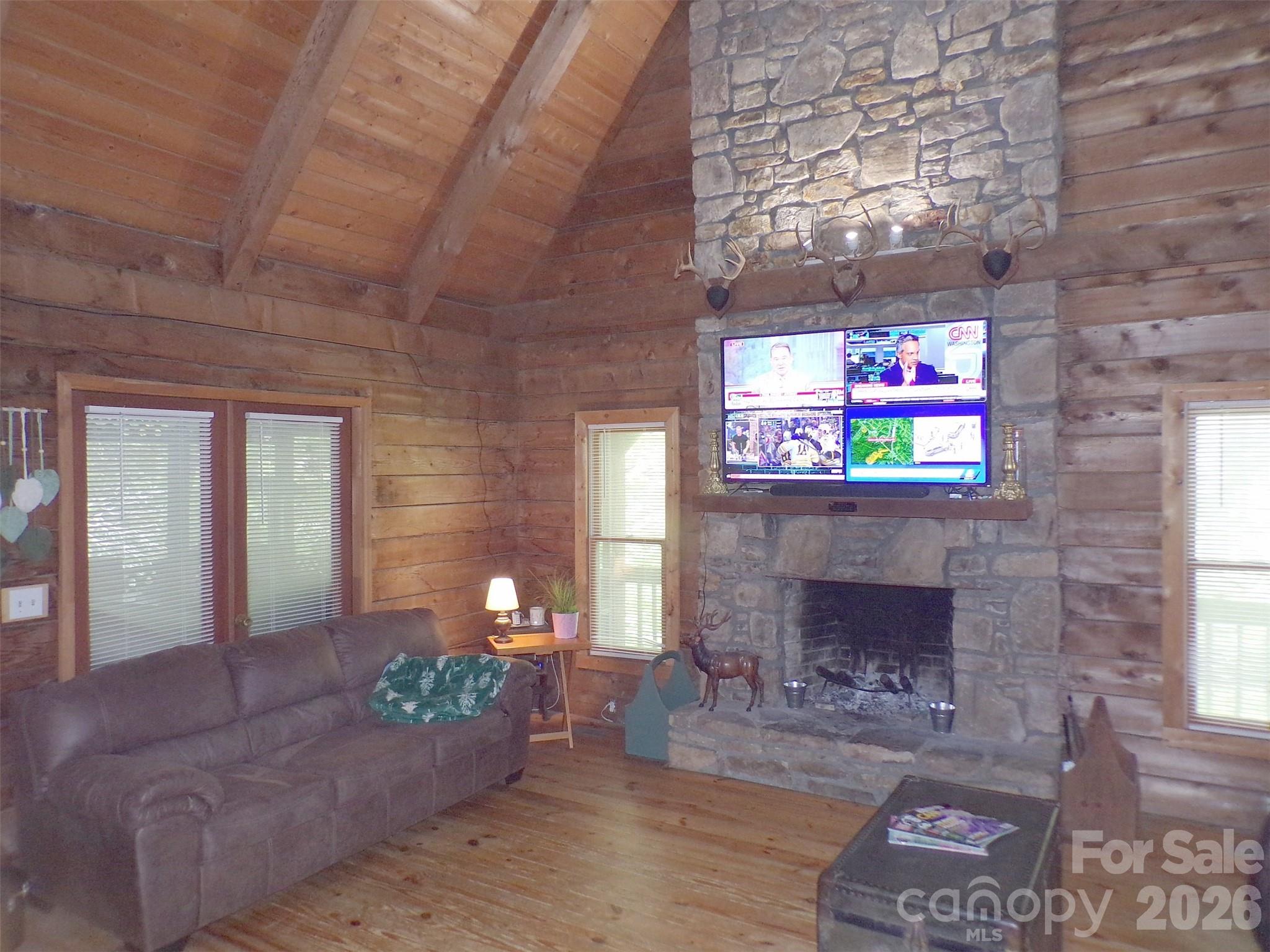 216 Paradise Road Hendersonville, NC 28792 - Photo 7 of 33 a living room with furniture and a fireplace
