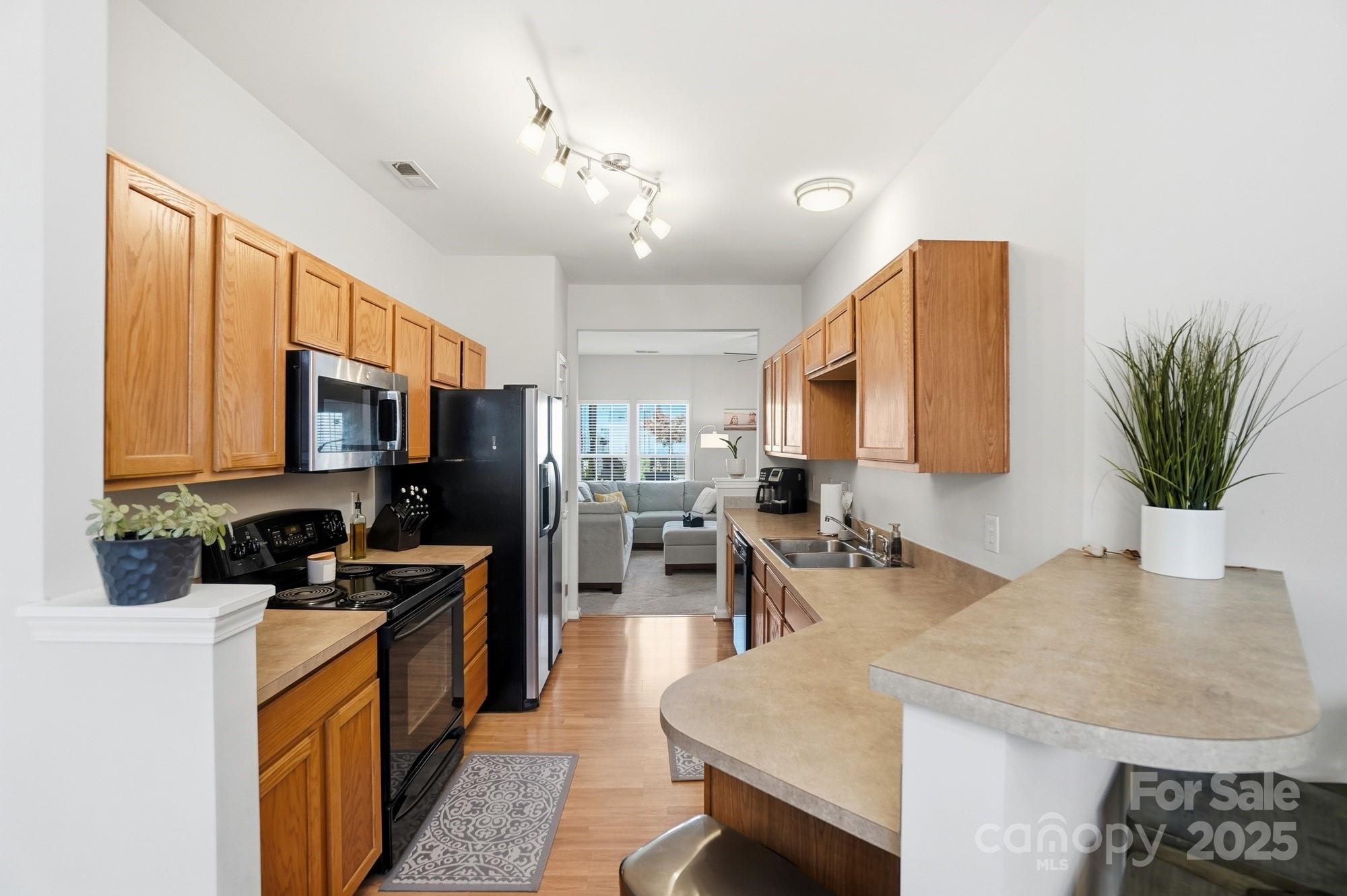 837 Dillard Road Rock Hill, SC 29730 - Photo 11 of 48 a kitchen with stainless steel appliances granite countertop sink stove refrigerator dining table and chairs