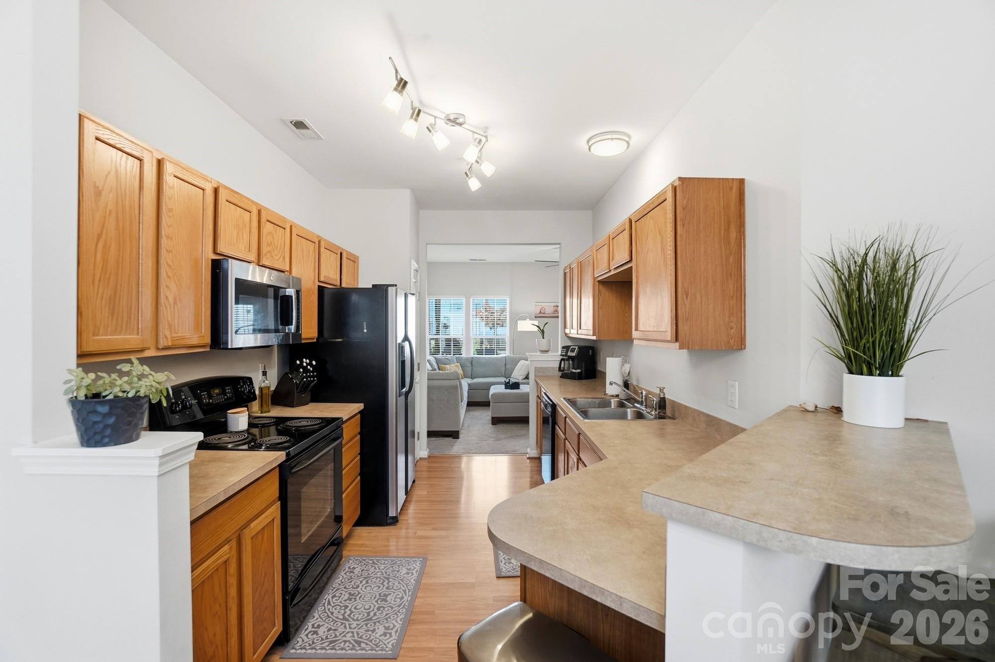 837 Dillard Road Rock Hill, SC 29730 - Photo 11 of 48 a kitchen with stainless steel appliances granite countertop sink stove refrigerator dining table and chairs