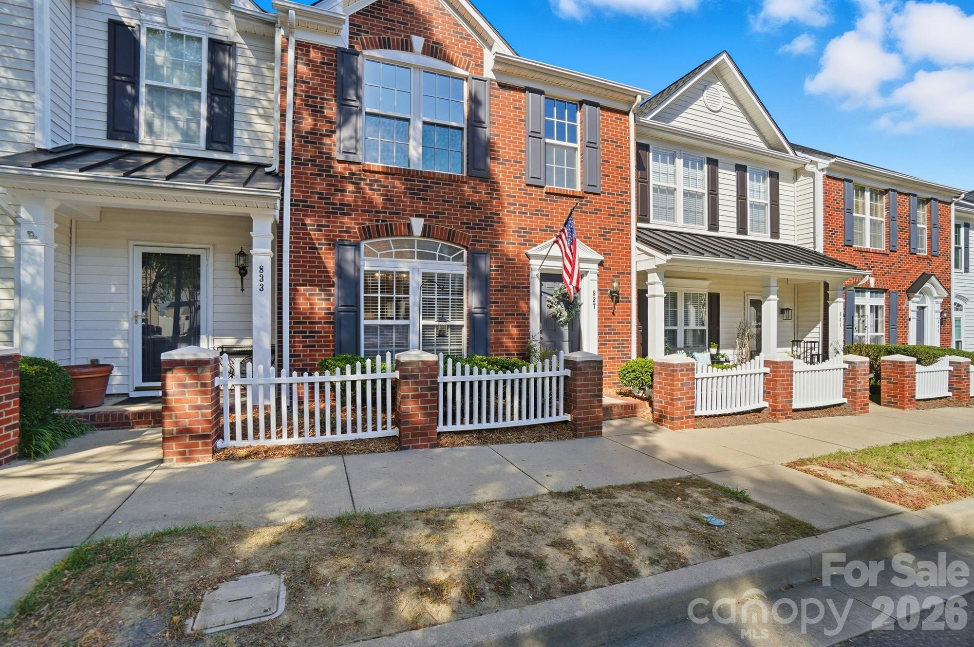 837 Dillard Road Rock Hill, SC 29730 - Photo 2 of 48 a view of a brick house with many windows and a yard