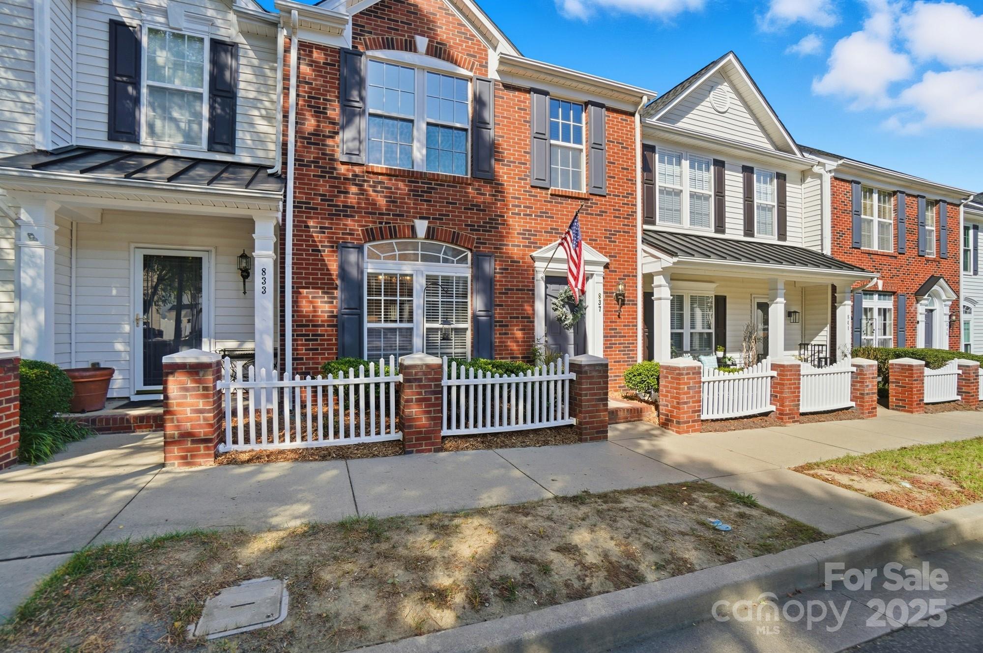 837 Dillard Road Rock Hill, SC 29730 - Photo 2 of 48 a view of a brick house with many windows and a yard