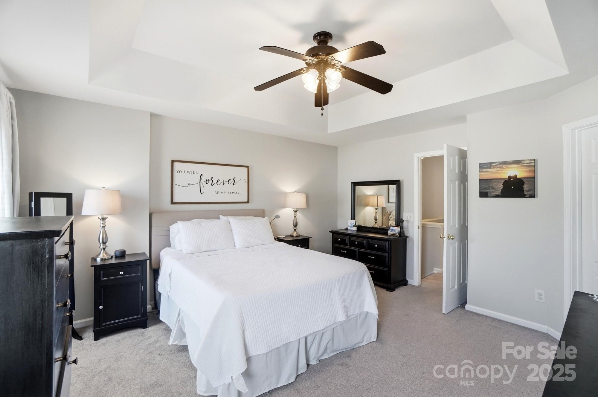837 Dillard Road Rock Hill, SC 29730 - Photo 25 of 48 a bedroom with a large bed and a chandelier