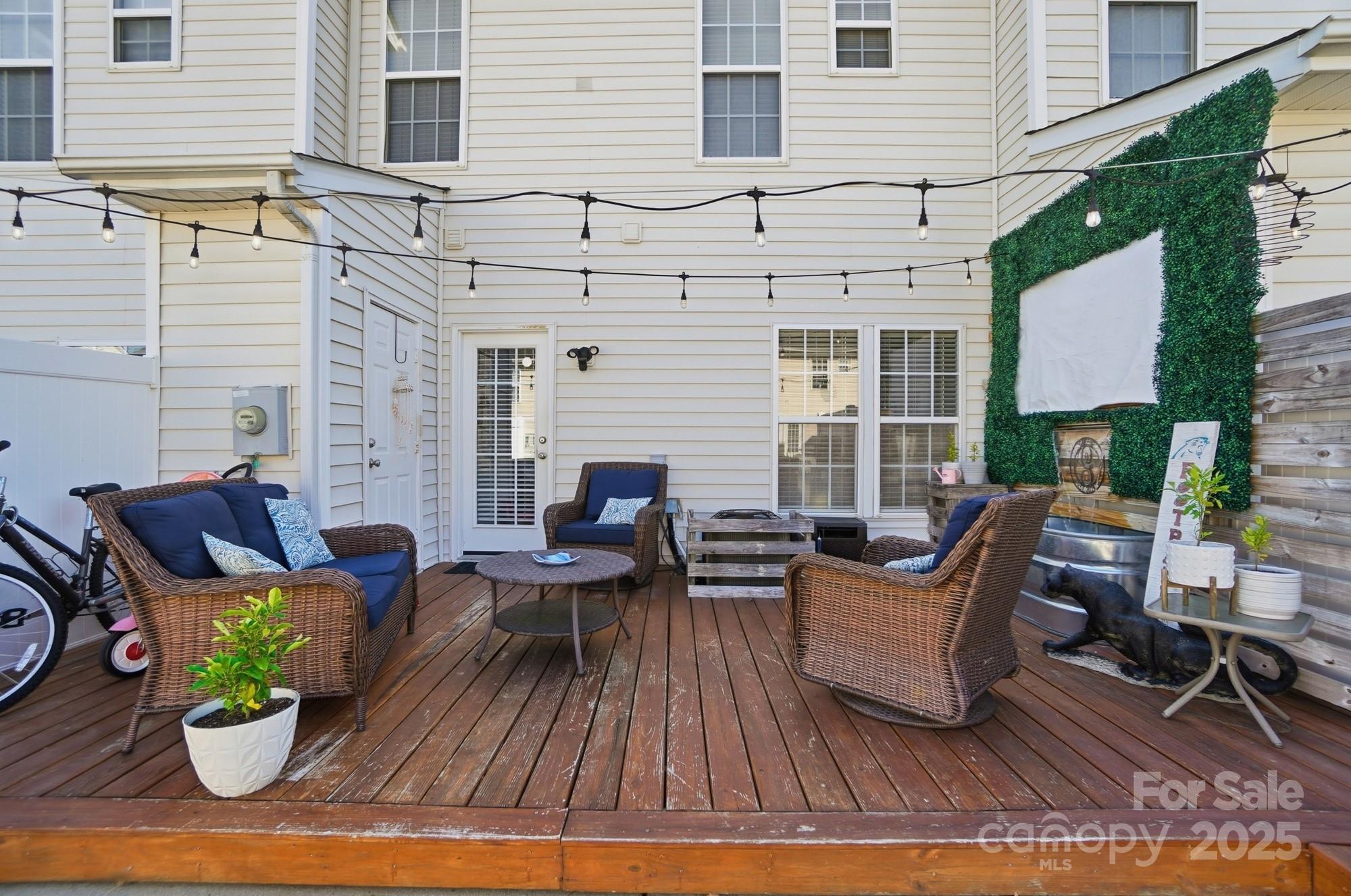 837 Dillard Road Rock Hill, SC 29730 - Photo 42 of 48 a view of a patio with couches chairs potted plants and wooden floor