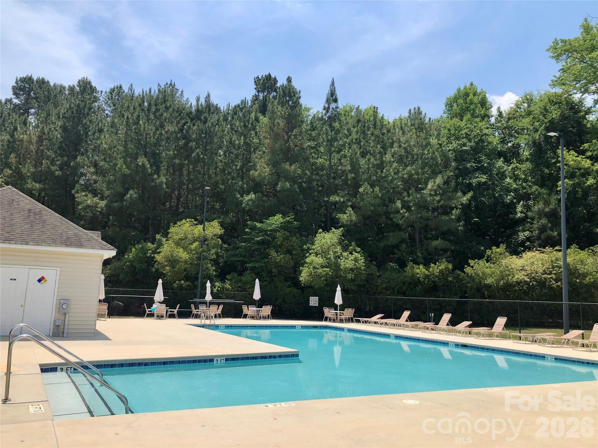 837 Dillard Road Rock Hill, SC 29730 - Photo 45 of 48 a view of a swimming pool with lawn chairs and a table and chairs