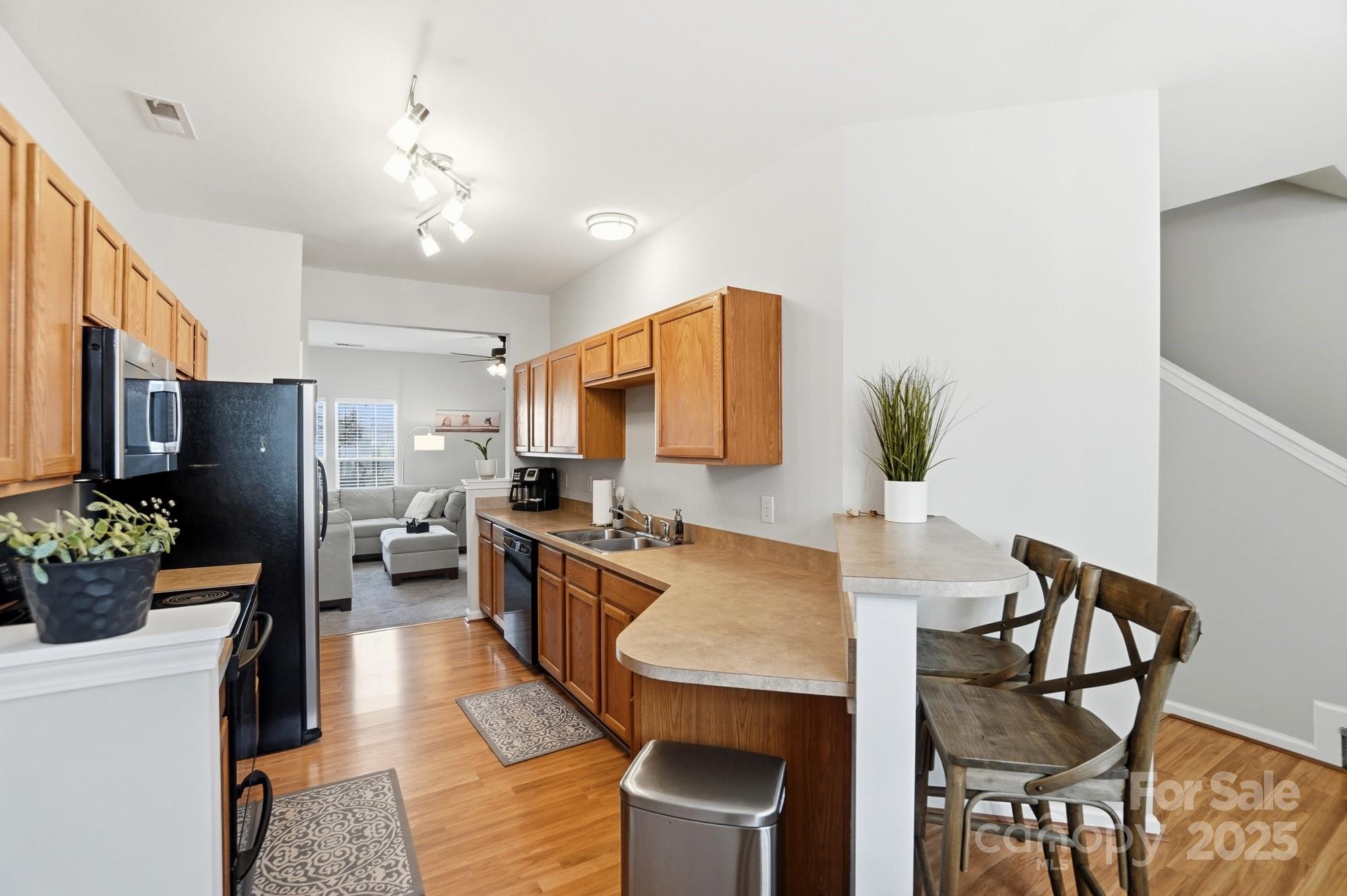 837 Dillard Road Rock Hill, SC 29730 - Photo 10 of 48 a view of a dining room with furniture a potted plant and wooden floor